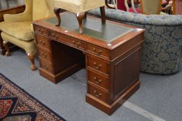 A reproduction mahogany pedestal desk.