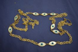 A silver necklace with Greek eye decoration.