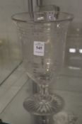 An engraved glass pedestal vase.