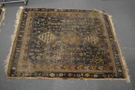 A small Persian rug, worn, 137cm x 112cm.