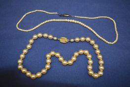 Two pearl necklaces.