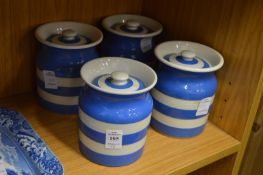 Four Cornish ware storage jars.