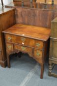 An 18th century walnut lowboy.