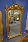 Decorative gilt framed mirror with cherub cresting, 160cm high x 85cm wide.