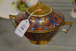 A gilt decorated twin handled bowl and cover.