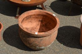 A large weathered terracotta garden plant pot.