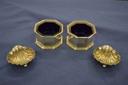A pair of octagonal shaped silver salts with glass liners and a pair of shell salts.