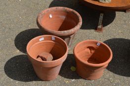 Three various terracotta plant pots.