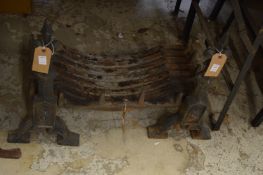 Pair of cast iron fire dogs and a grate.