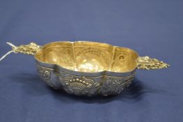 A Continental silver twin handled dish with embossed decoration.
