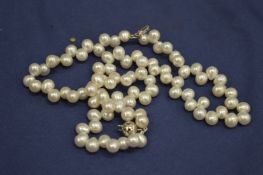 A decorative pearl style necklace, boxed.