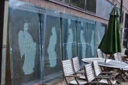 A set of six very large glass sliding doors etched with heraldic beasts.