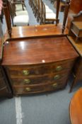 A Victorian style mahogany small bow front chest of drawers.