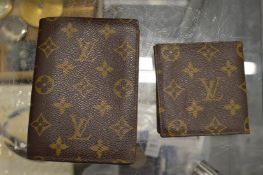 Two Louis Vuitton wallets.