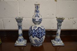 A Dutch blue and white baluster shaped vase and pair of similar candlesticks.