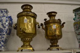 Two brass samovars.