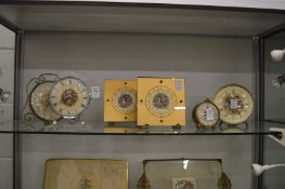 A collection of decorative mantel or bedroom clocks.