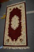 A Chinese rug, 150cm x 78cm.