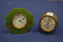 A Swiza barrel shaped bedside clock and another clock.