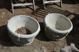 A pair of classical style composite garden planters.