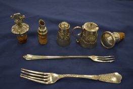 Three bottle stoppers, a mustard and pepper and two forks.