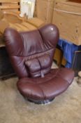 A large stylish maroon leather cloth upholstered swivel chair.