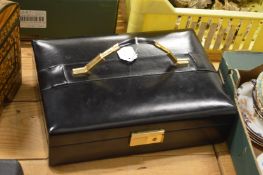 A black leather jewellery case with fitted interior.