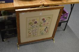 An embroidered fire screen.