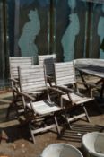 A set of four garden hardwood folding armchairs.