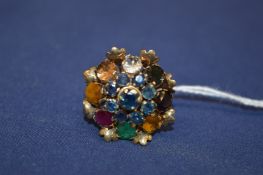A 14ct gold multi colour gem set flower head ring.