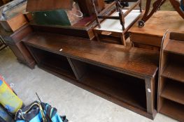 A long low oak open book shelf.