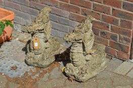 A pair of composite dragon shaped gate post finials or water features.