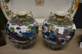 A pair of Chinese bulbous shaped vases decorated with dragons.