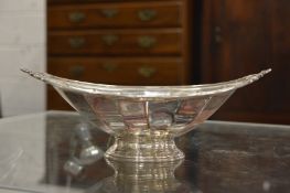A silver oval shaped pedestal bowl.