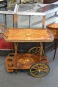 Decoratively inlaid drinks trolley.