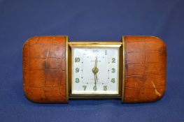 A leather bound travelling clock.