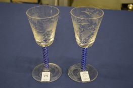 A pair of Continental wine glasses with blue and clear air twist stems.