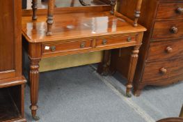 A 19th century mahogany two drawer side table with reeded legs.