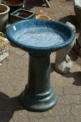 A glazed pottery bird bath (crack to rim).