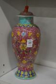 A Chinese famille rose baluster shaped vase and cover.