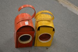 Two old road work lanterns.