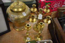 An Eastern brass jar and cover, candelabra and a pair of candlesticks.