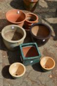 Seven various garden plant pots.