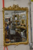 A small gilt framed mirror.
