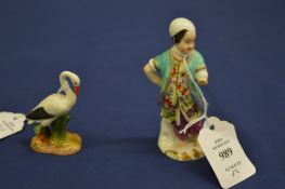 A small porcelain figure of a boy and another of a bird (faults).