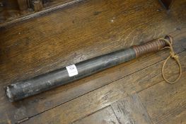 A turned wood truncheon.