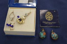 Two enamel Russian egg shaped pendants and two decorative necklaces with pendants.