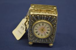 A silver cased miniature carriage clock with enamel dial.