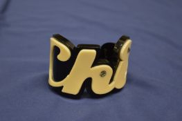 A stylish bangle forming the word chic.