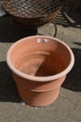 A large terracotta plant pot.